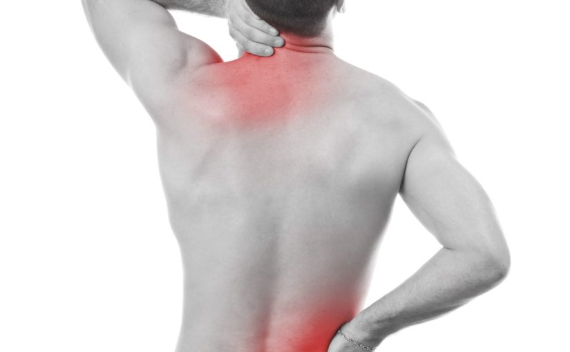 13683502 - young man having pain in his neck and back, monochrome photo with red as a symbol for the hardening